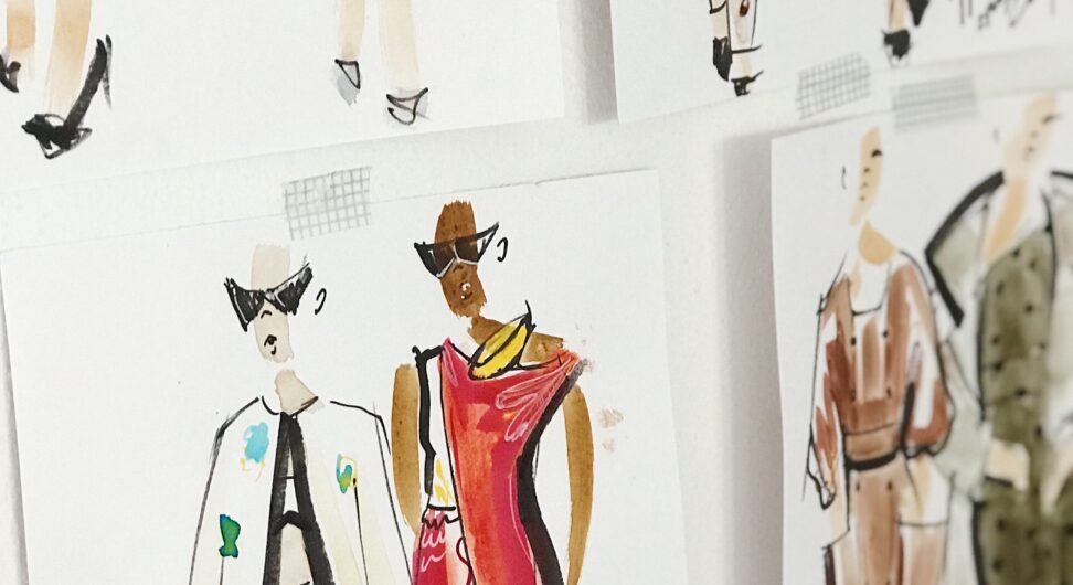 Sketches of fashion outfits pinned to a white board.